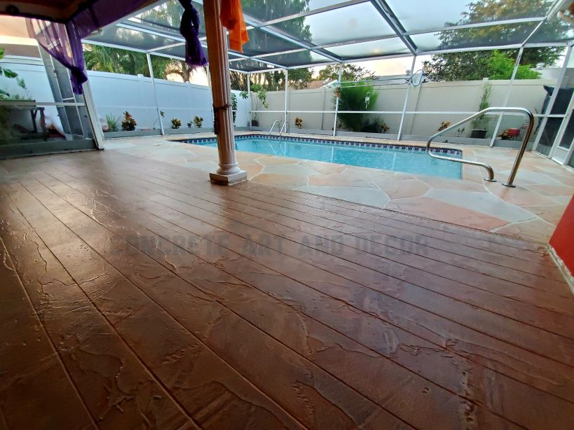 Picture of a pool deck finished in an amazing wood plank stamped concrete pattern..
