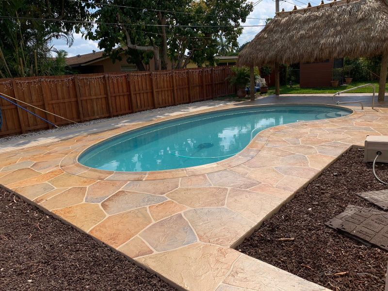  stamped concrete pool deck in natural tone rustic stone pattern